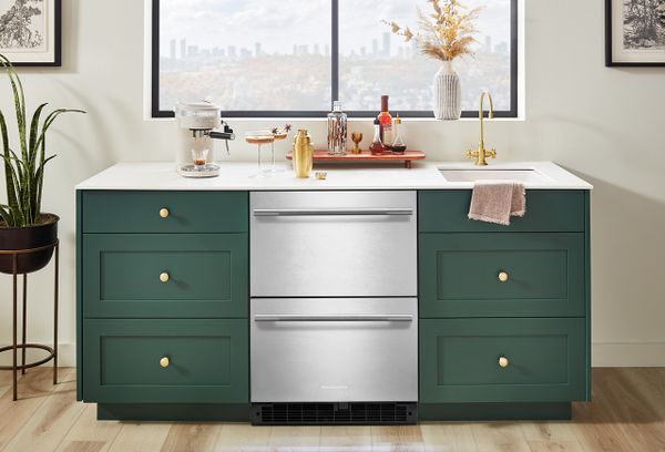 The KitchenAid KURT524SSB drawer refrigerator installed into green cabinetry 