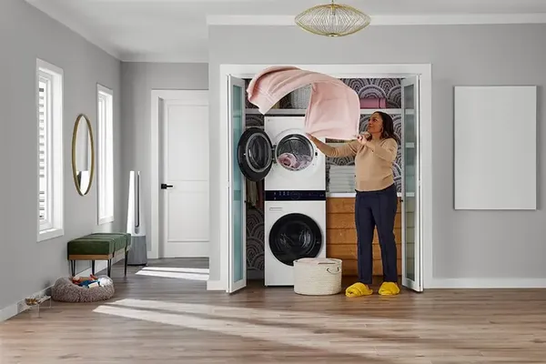 A wide shot of a woman using the LG WKHC152HWA WashTower 