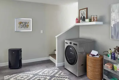 The LG WM6998HVA washer dryer combo in a laundry room