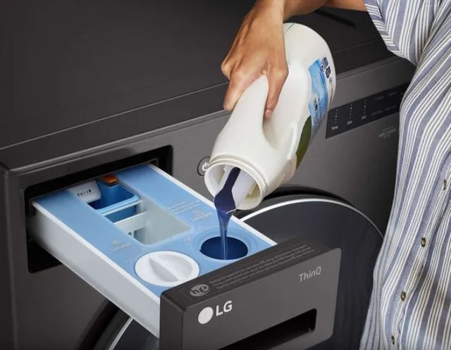 close view of a person pouring laundry detergent into an LG ezDispense turbowash washer