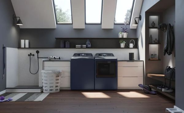 A laundry room with blue GE Profile top load washer and dryer
