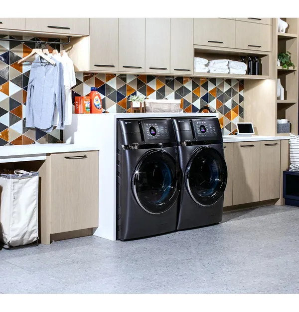 A matching GE Profile front load washer and dryer in a laundry room