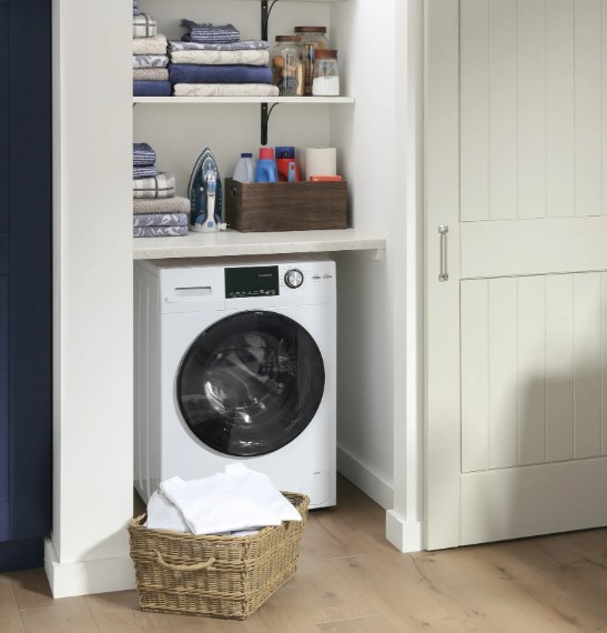 GE washer dryer combo in a closet beneath shelves containing other laundry essentials