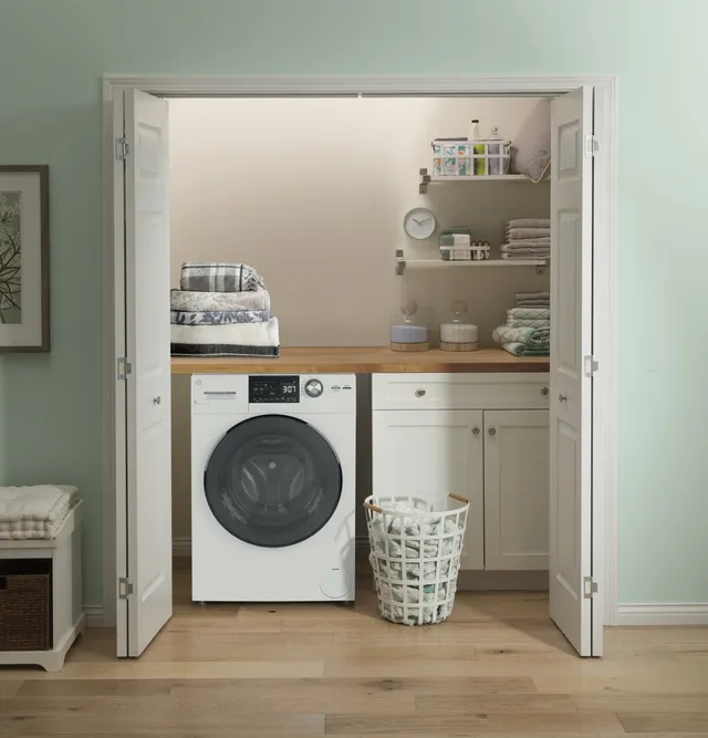 The GE GFQ14ESSNWW washer/dryer combo in a laundry room 