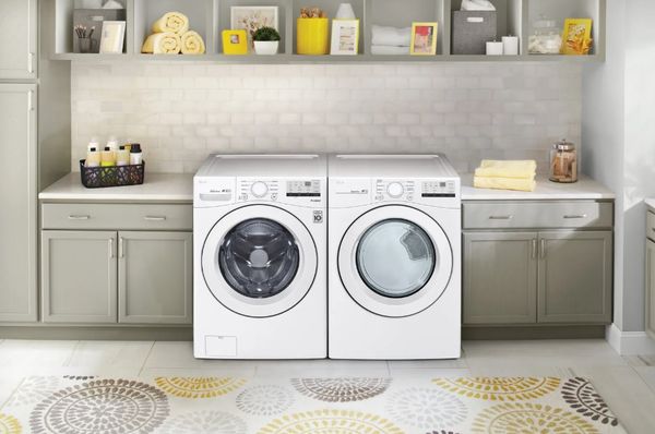 White LG front load washer and dryer in a laundry room