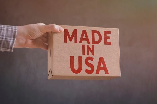 A person holding a box with Made in the U.S.A. written on it 