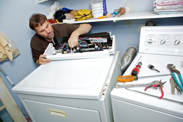 A man repairing a dryer 