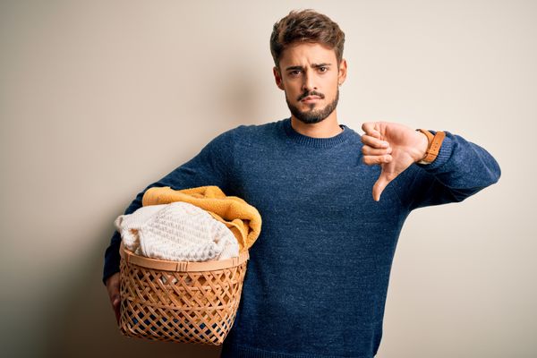 A man holding a basket giving a thumb down 