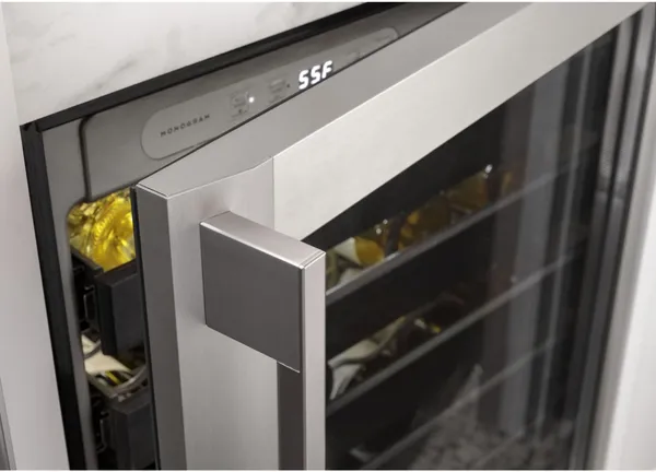 A close-up of the Monogram ZDWR240NBS wine cooler with its door open 