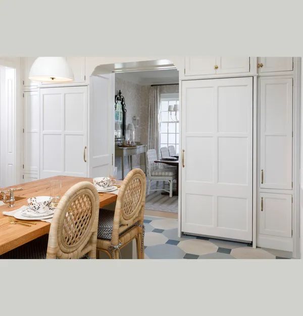 The Monogram ZIR361NBRII column refrigerator with a custom white panel in a luxury kitchen 
