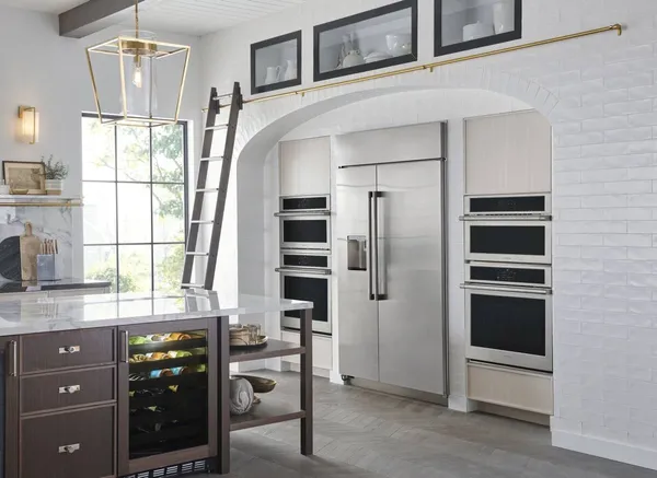 The Monogram ZISS480DNSS refrigerator featured with matching brand appliances in a luxury kitchen 