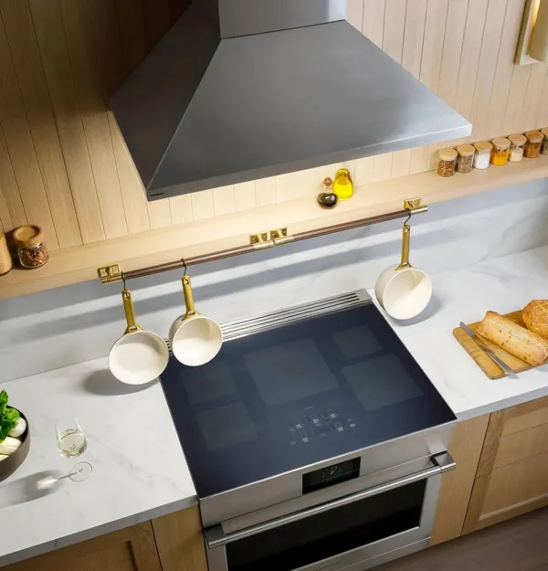 The Monogram ZVIS361SRSS range hood over a stove 