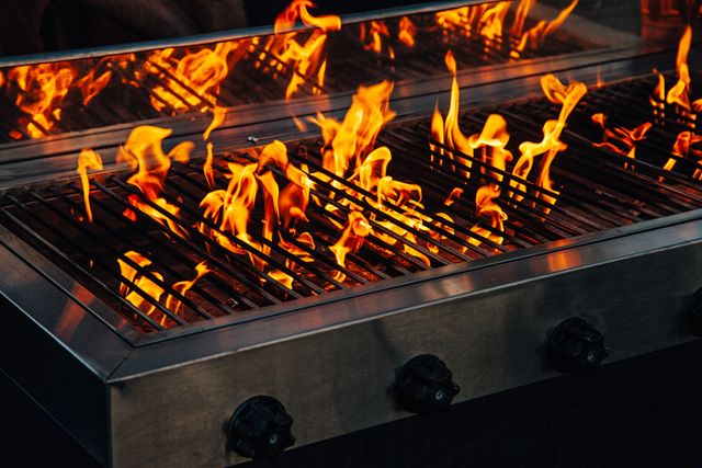 View of a gas grill with flames all over