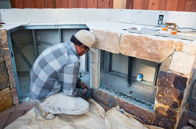 Front view of a man preparing to install an outdoor fridge in a kitchen