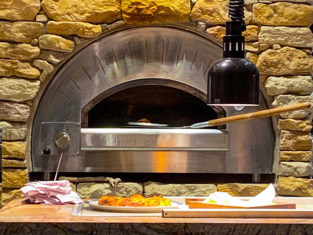 Front view of a built-in outdoor pizza oven 
