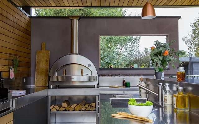 front view of a large outdoor kitchen with a coutertop pizza oven