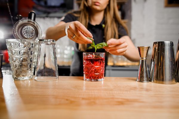 A woman preparing a cocktail 