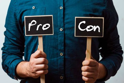Man Holding Pro Con Signs