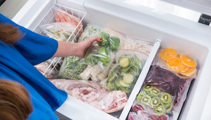 A well-organized deep freezer filled with bulk foods