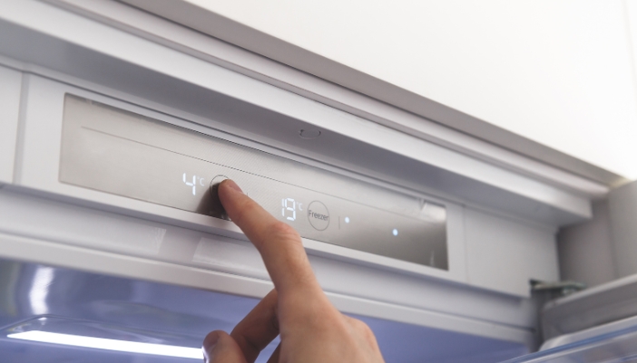 Closeup of someone adjusting the temperature on their refrigerator