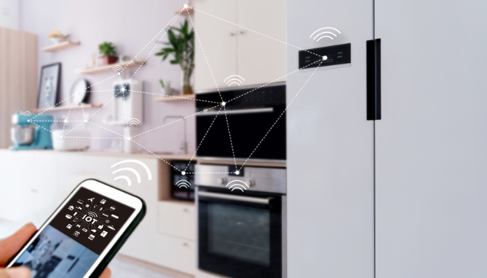 A person uses a phone to operate their smart kitchen appliances.
