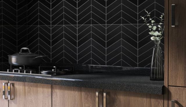 close view of a modern black backsplash with brown wood cabinets