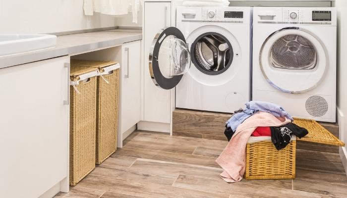 Laundry room with bins in undercabinet space