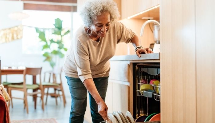 woman loading her dishwasher