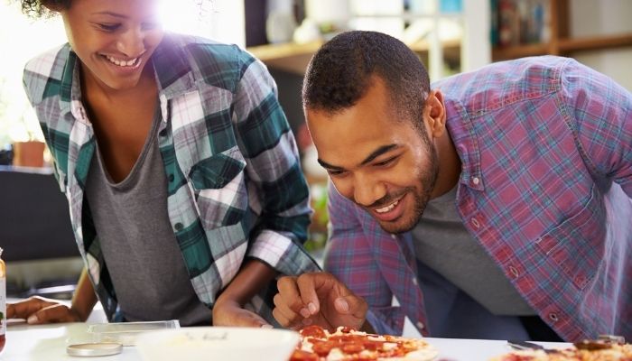 Man and woman making pizza 