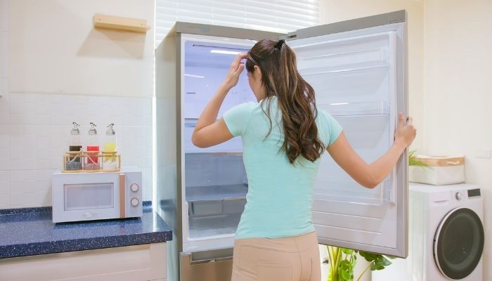 Woman looking in freezer