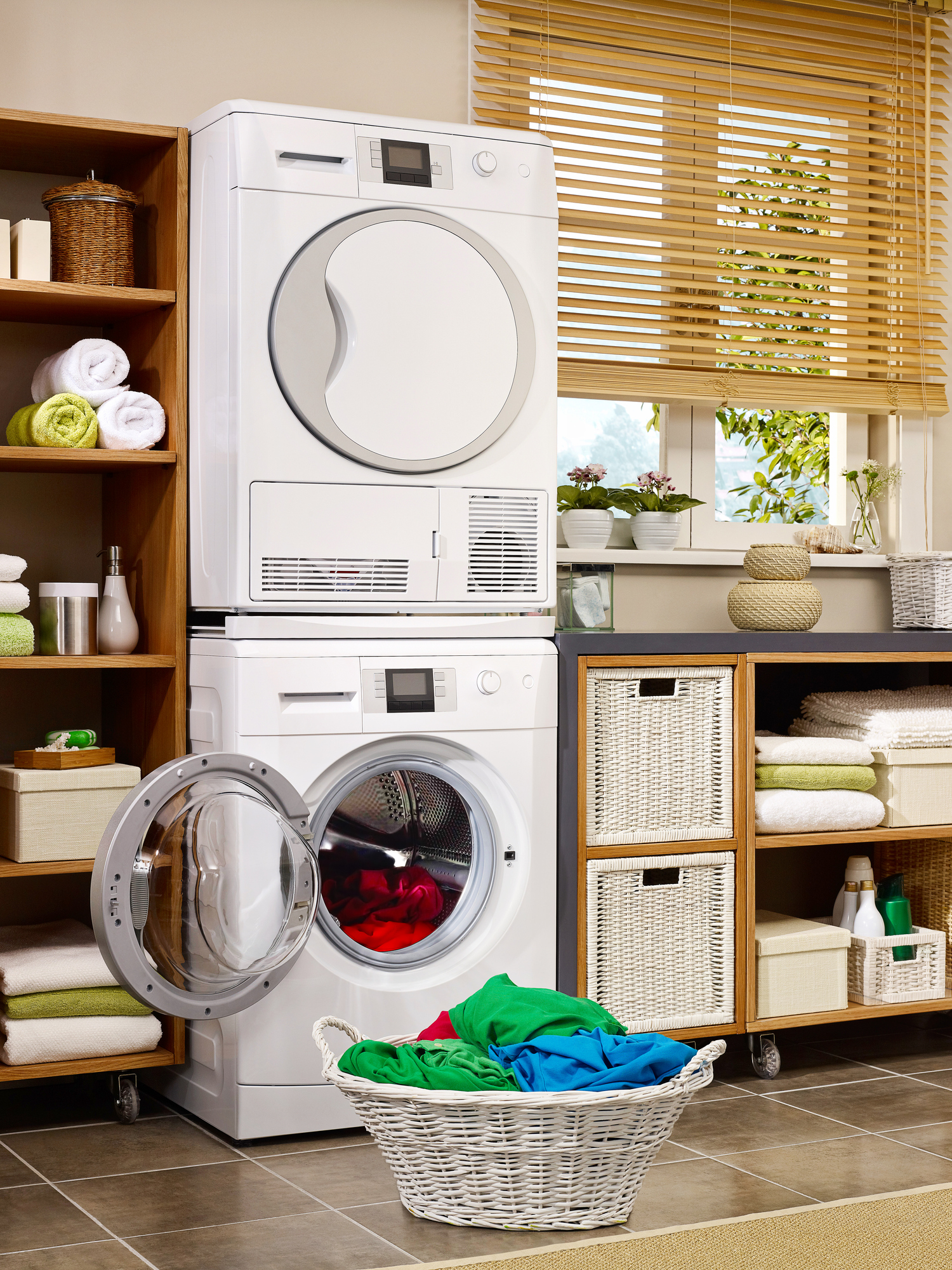 stacked washer and dryer with basket of clothing