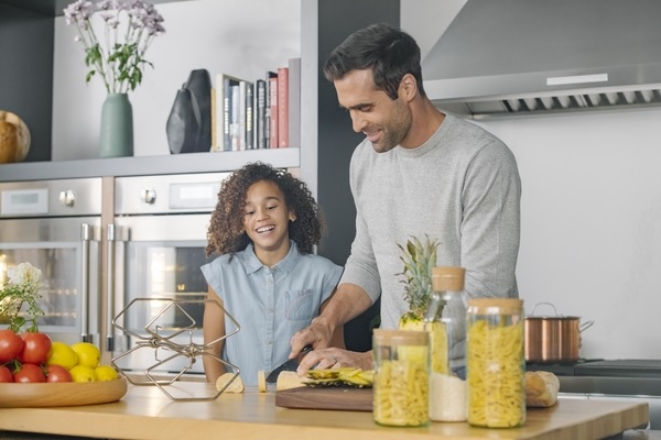 father and daughter preparing meal in front of Thermador wall oven