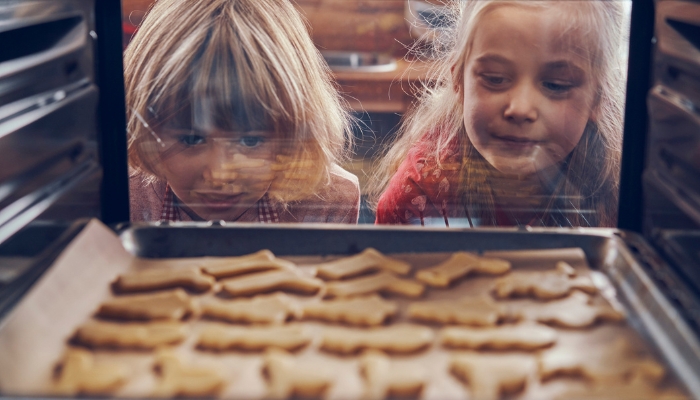 Two girls eagerly awaiting their cookies