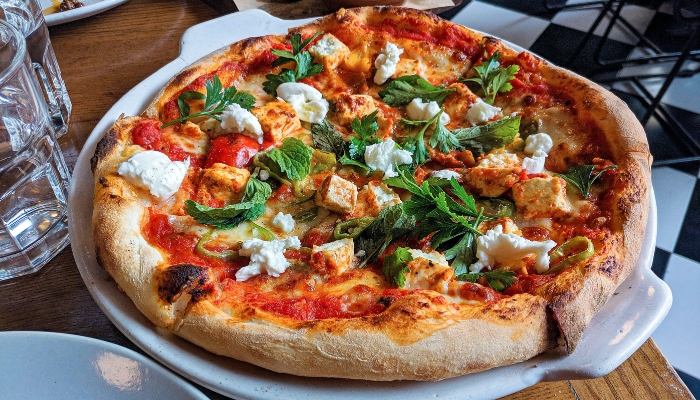 Thick crust pizza with toppings on plate