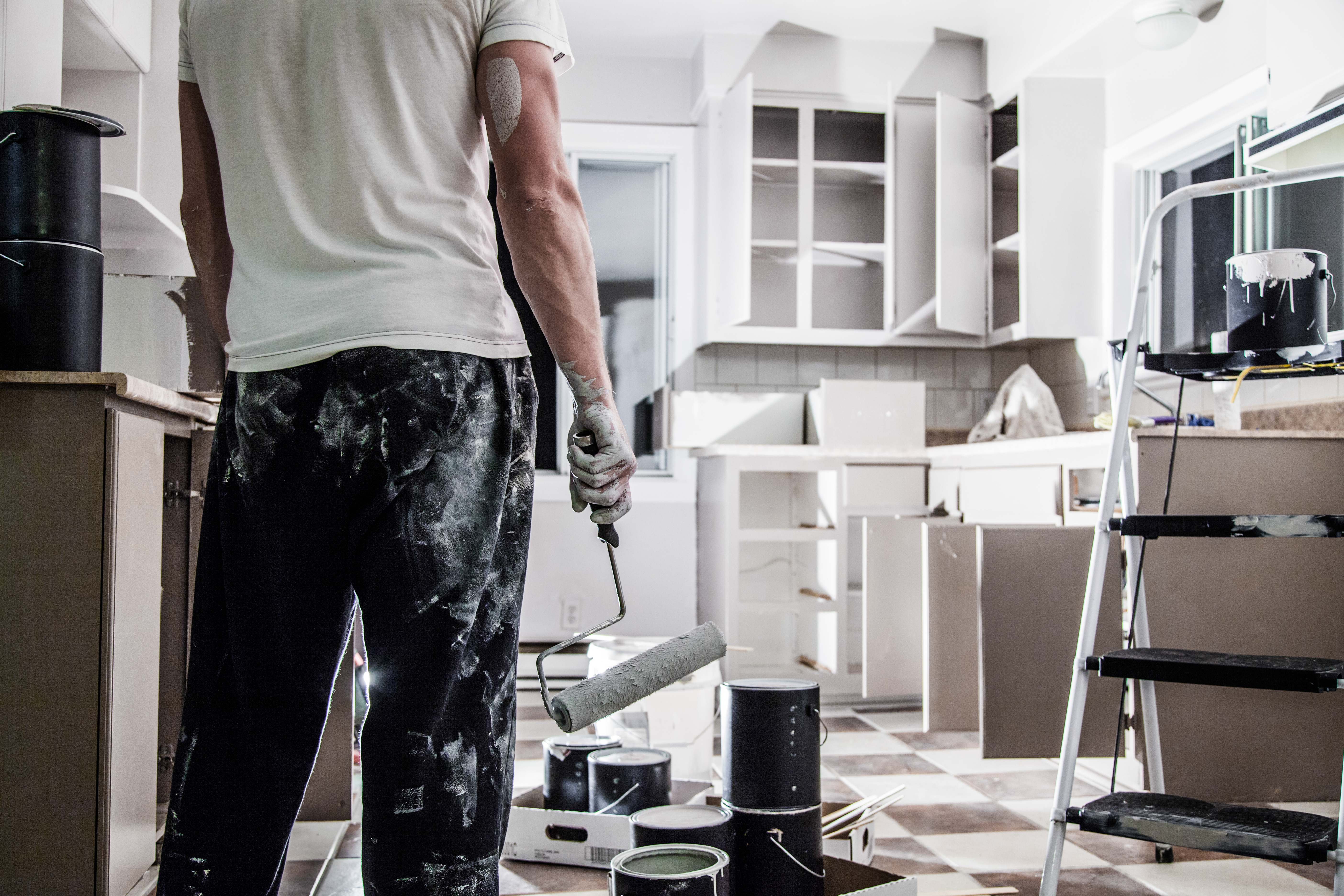 man painting kitchen cabinets