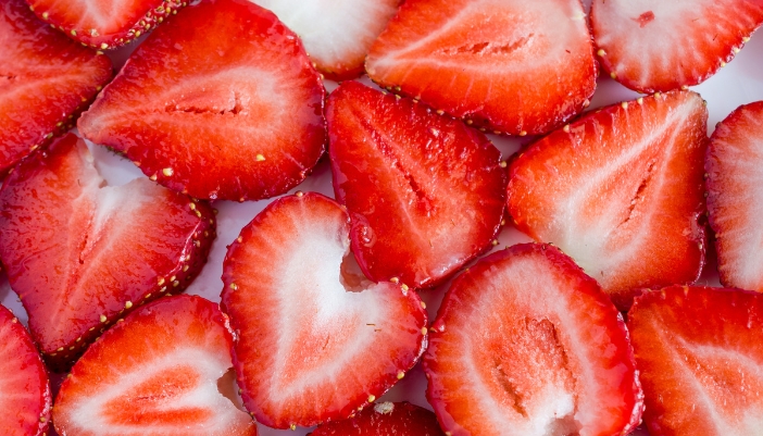 A flatlay of sliced strawberries.
