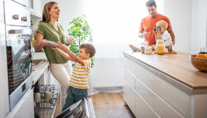 A family does the dishes together at home. 
