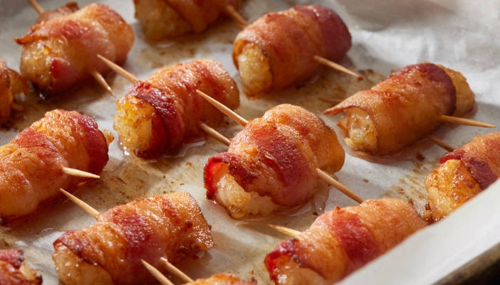 A tray with bacon-wrapped tater tots.