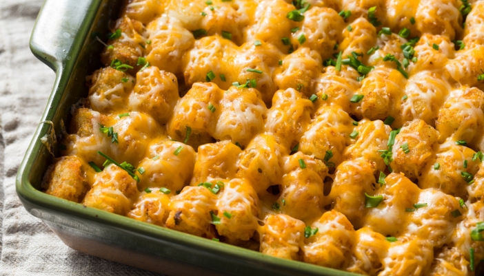A casserole dish with a tater tot meal inside.