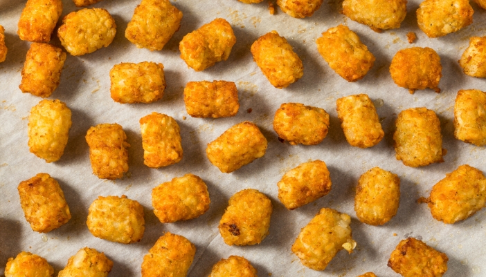 A tray of crispy, fresh tater tots.