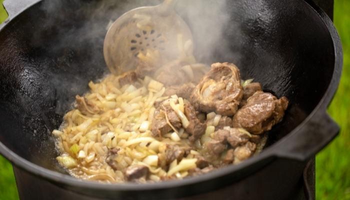 Food in cast iron pan with steam coming off
