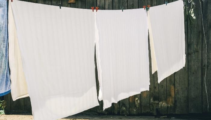 Hanging linens to dry on clothesline