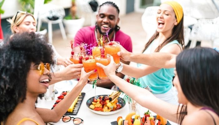 Five friends toasting cocktails