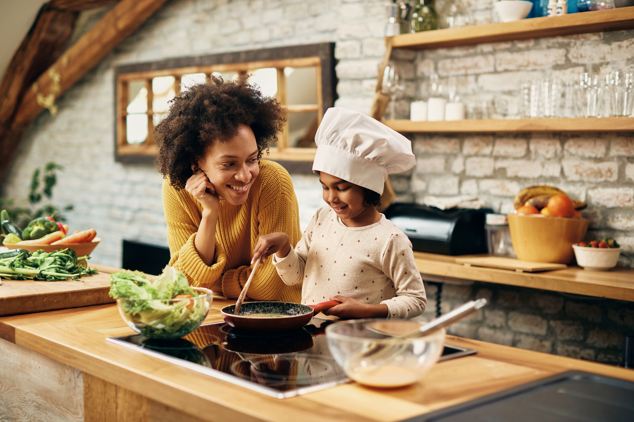 Mother and daughter cooking on a GE range
