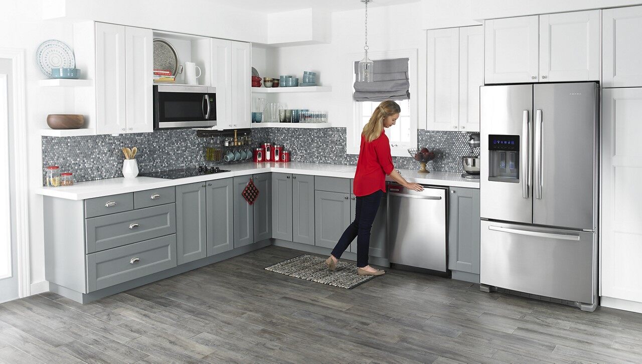woman in kitchen with bottom freezer refrigerator