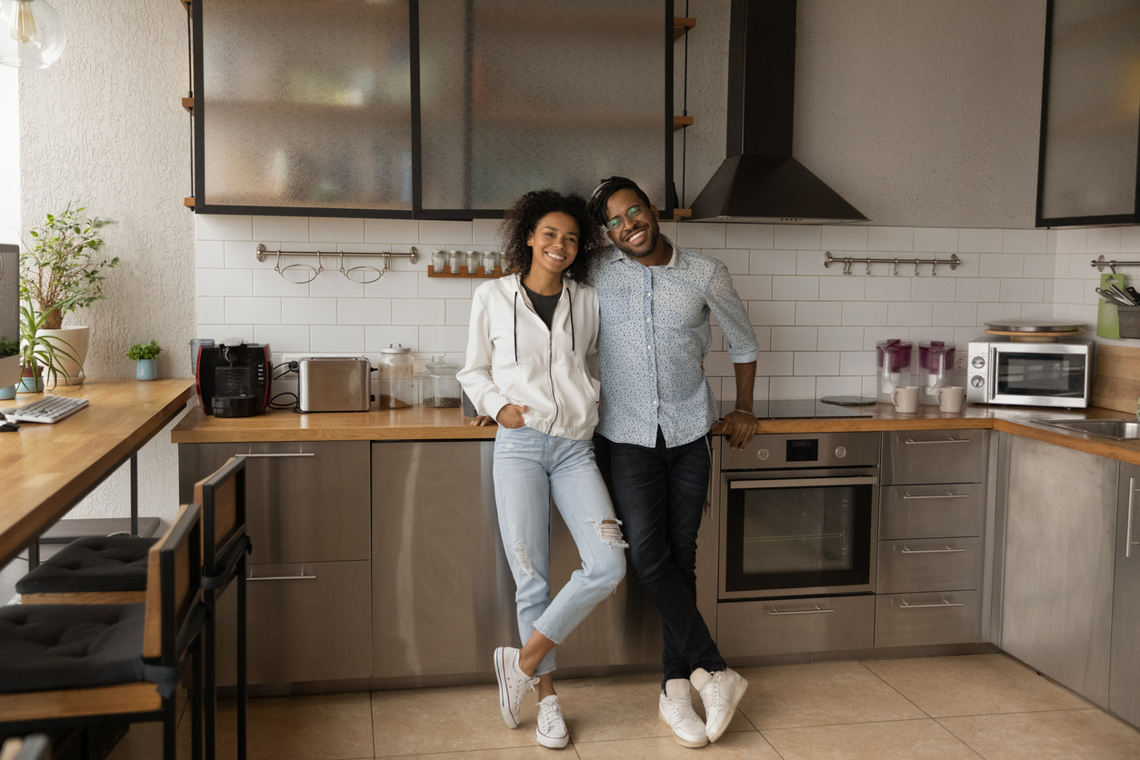 Couple standing in front of appliance