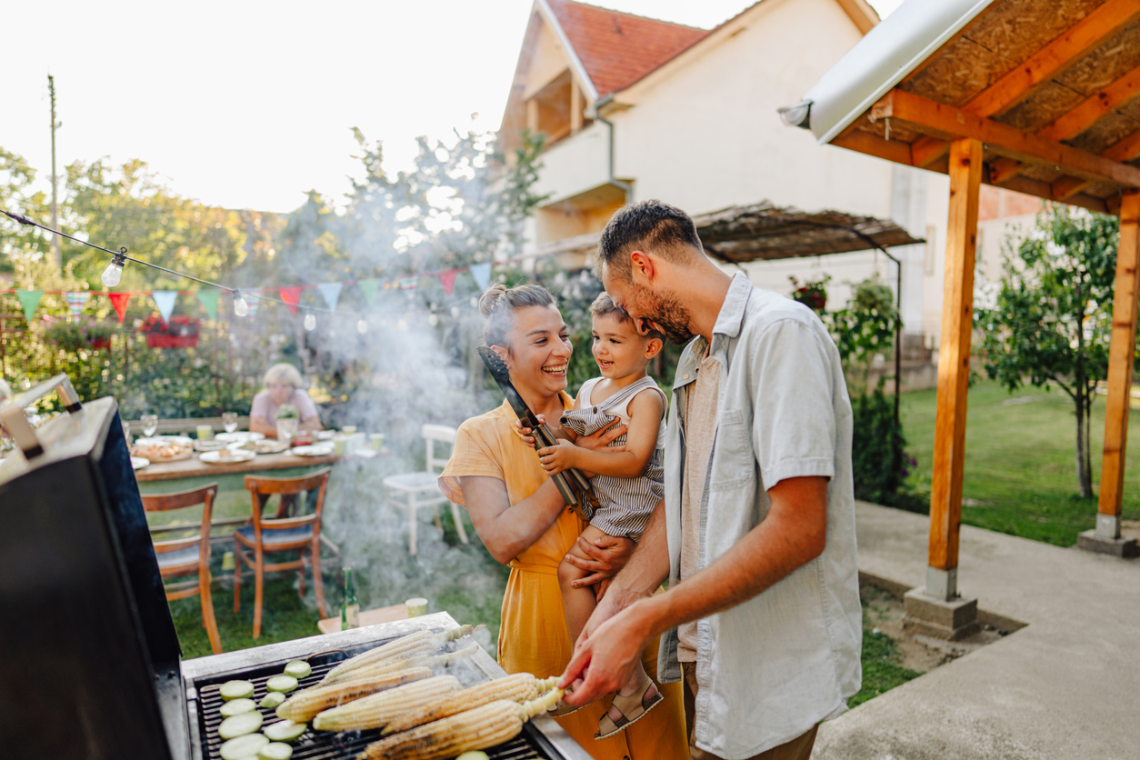 family grilling during a backyard BBQ party