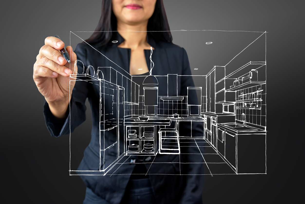 Woman mapping out interior design of modern kitchen