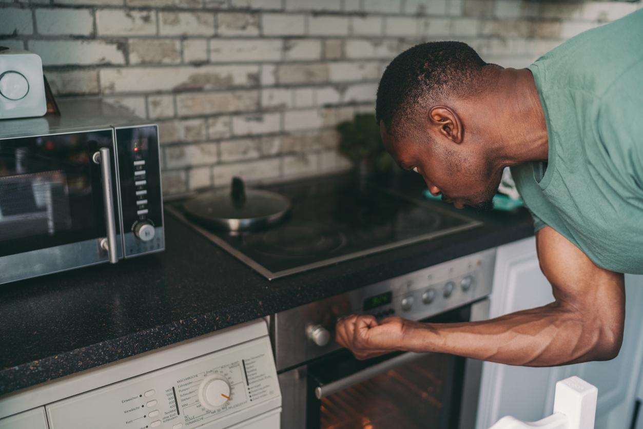 man turning stove knob