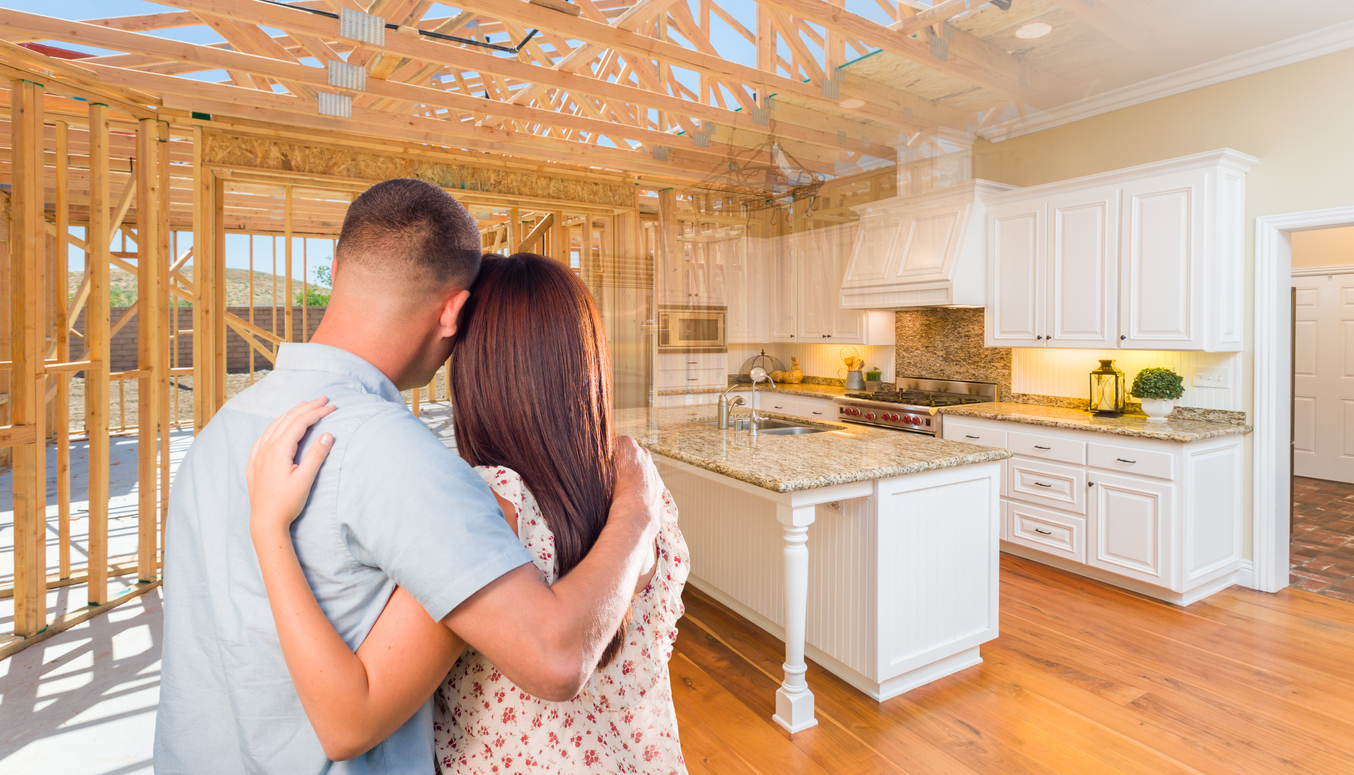 Couple looking at home being built